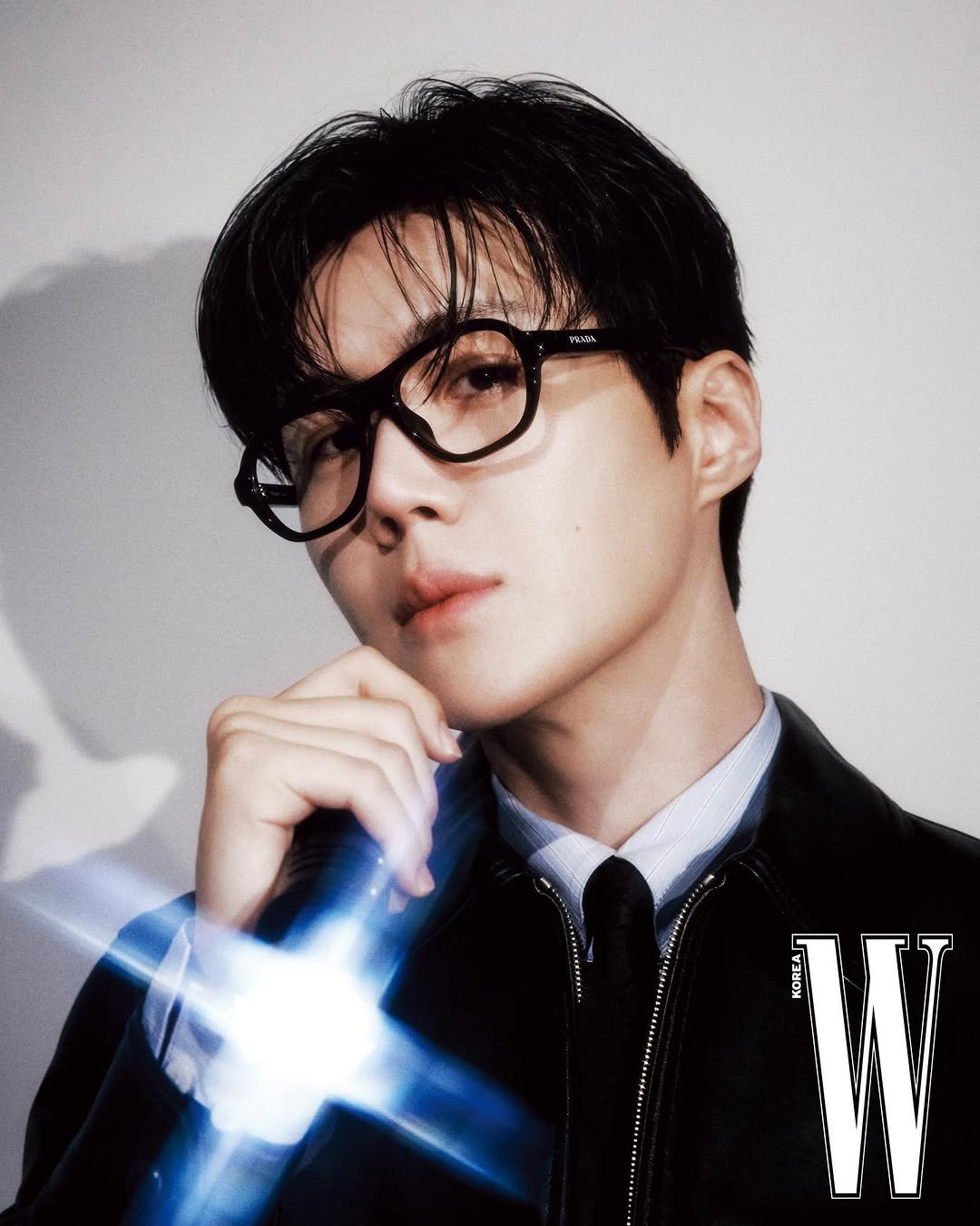 Photo shared by 김선호 on December 28, 2025 tagging @wkorea. May be an image of eyeglasses, bolo tie and text.