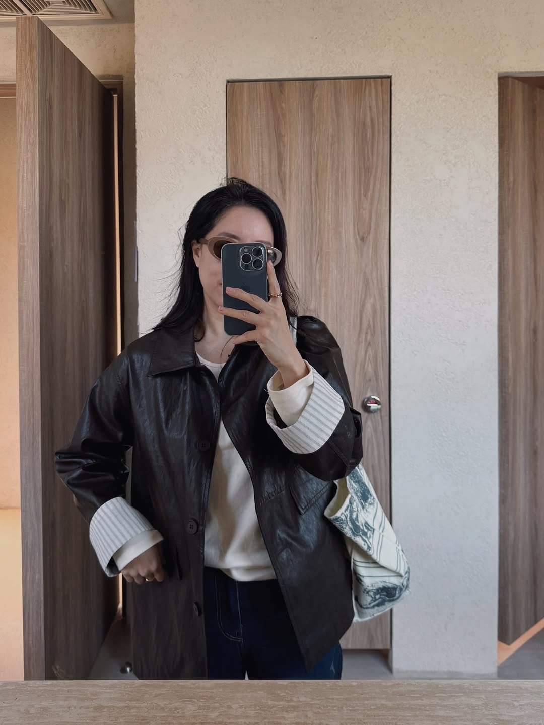Photo by sera jung on November 12, 2025. May be an image of duffle coat, mirror, jacket and text.