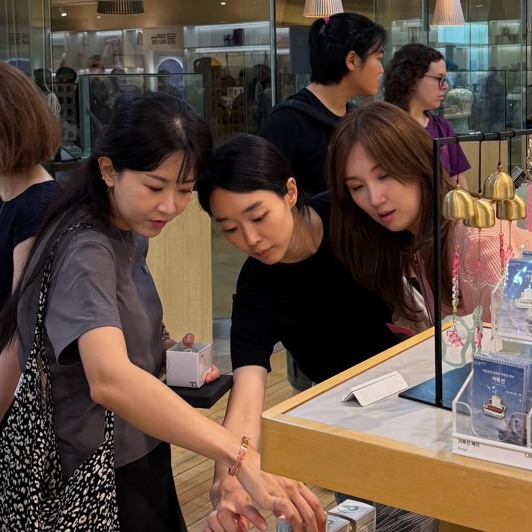 Photo by Jim Kim on August 29, 2025. May be an image of 4 people, display case and text.