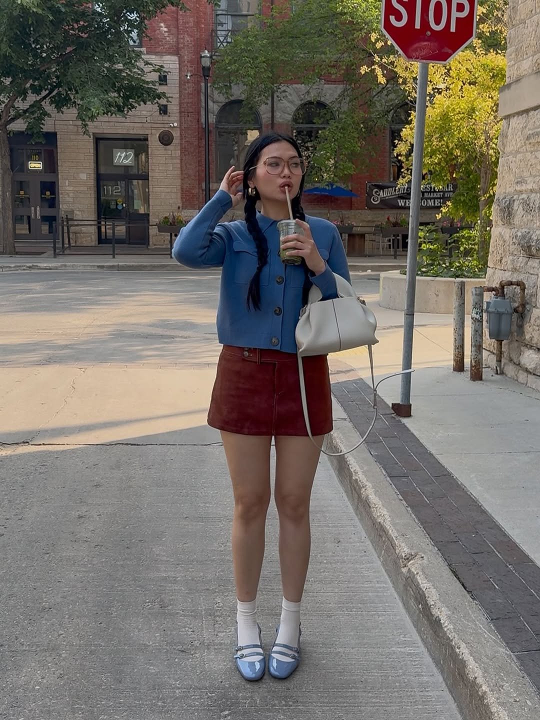 Photo by Shayne Hydn on August 19, 2025. May be an image of 1 person, miniskirt, cornflower, street and text.