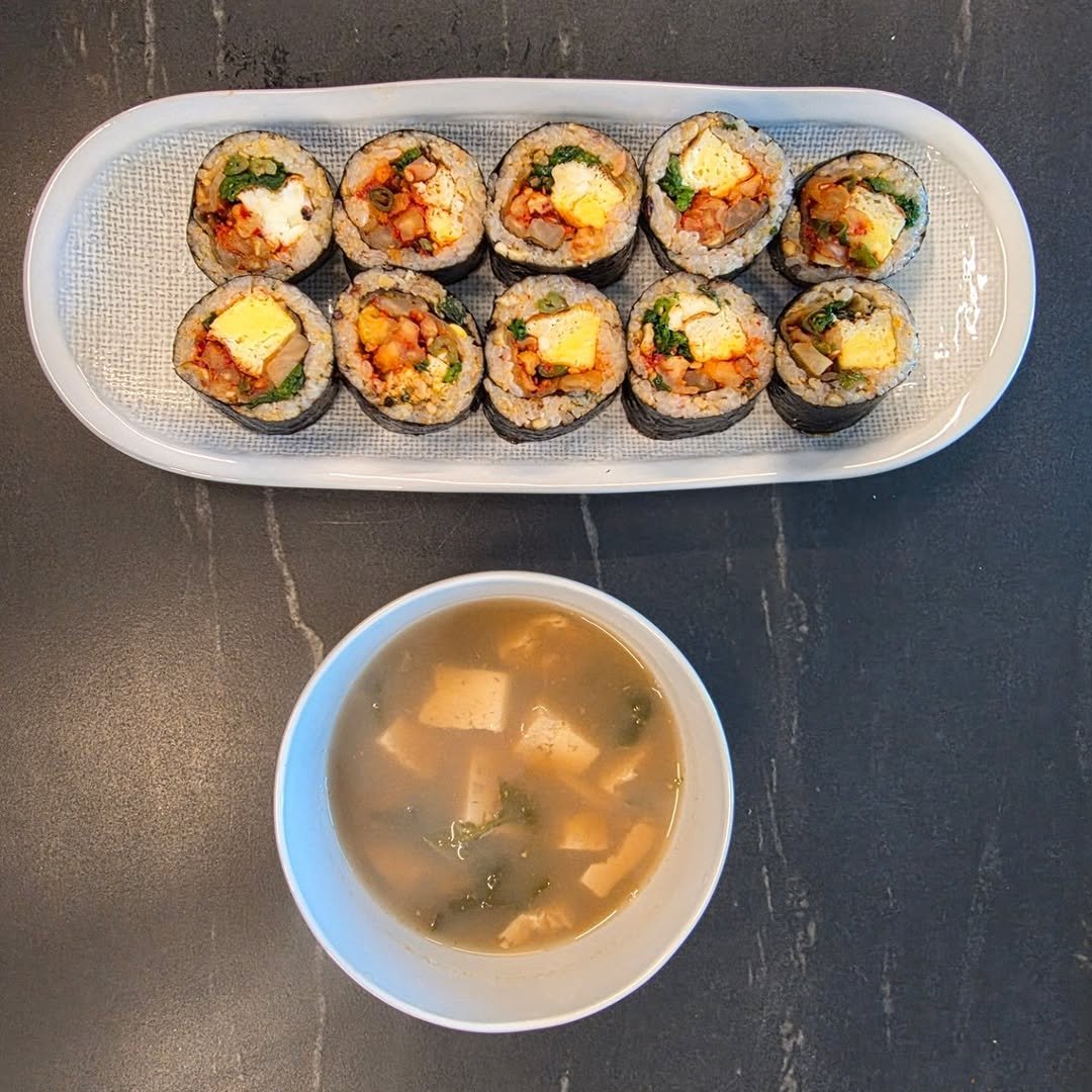 Photo by 신애라 on January 21, 2026. May be an image of sushi, tofu, rice, seaweed, chopsticks and text.