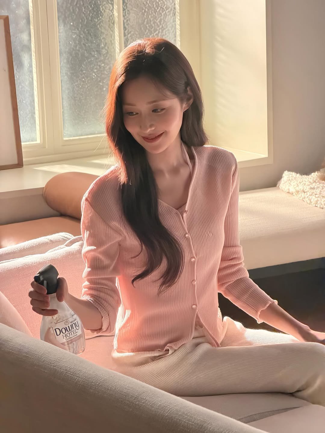 Photo shared by 신슬기 Shin Seul Ki on March 29, 2026 tagging @downy_korea. May be an image of one or more people, makeup, sleepwear, top, sweater, cardigan, perfume and text.