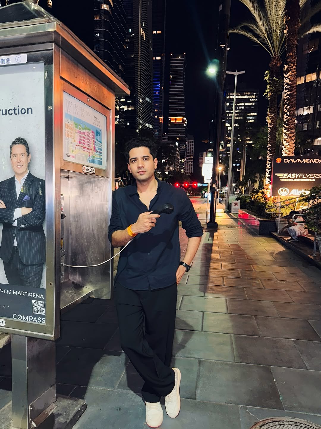 Photo by Shivam malik in Brickell, Miami, Florida. May be an image of 3 people, phone, Times Square, street and text.