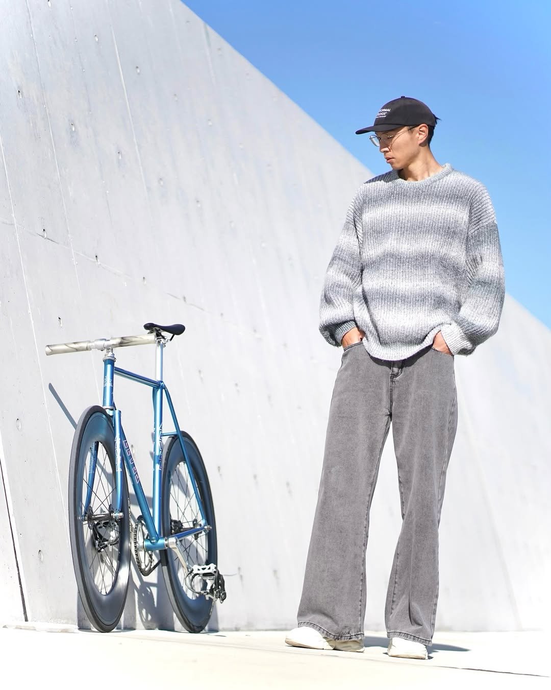 Photo shared by shota on December 07, 2025 tagging @pasnormalstudios, and @minimalhouse1. May be an image of bicycle, duffle coat, skateboard, sweater, sweatpants and text.