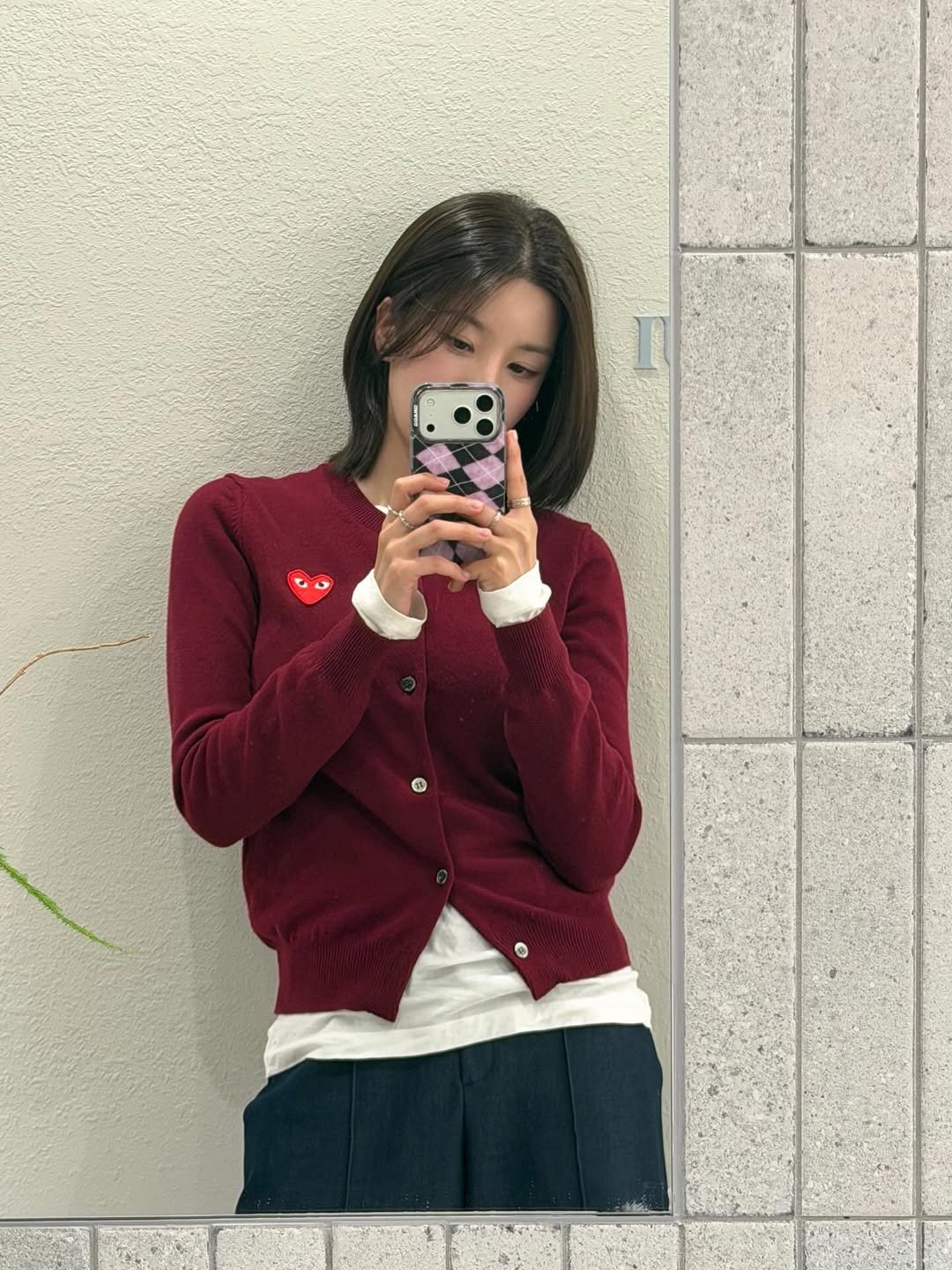 Photo by 권은비 on February 14, 2026. May be a selfie of one or more people, hair, duffle coat, mirror, cardigan, miniskirt, sweater and text.