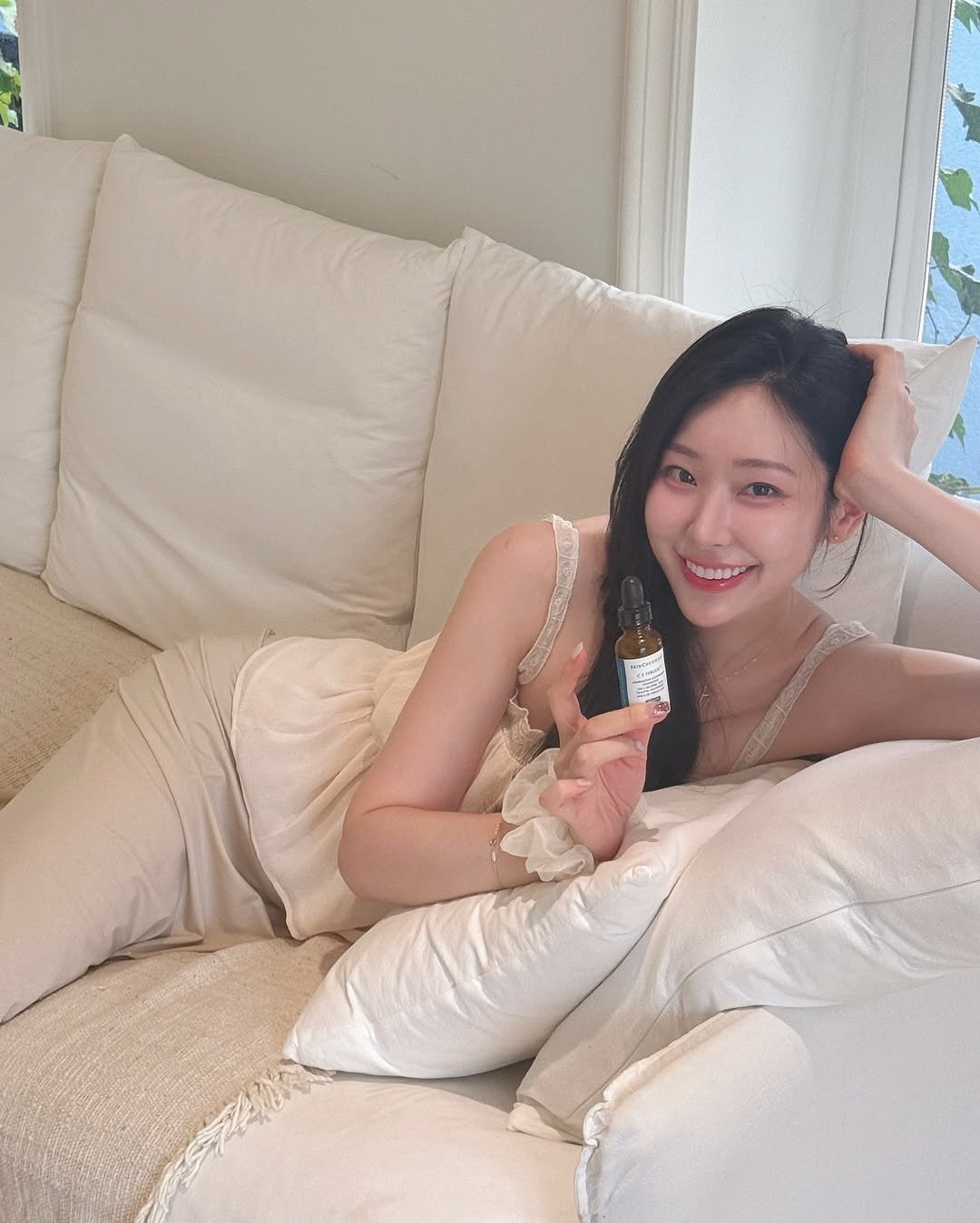 Photo shared by 심톨 𝐒𝐈𝐌𝐓𝐎𝐇𝐋 on August 22, 2025 tagging @skinceuticals. May be an image of 1 person, hair, sleepwear, chaise lounge and text.
