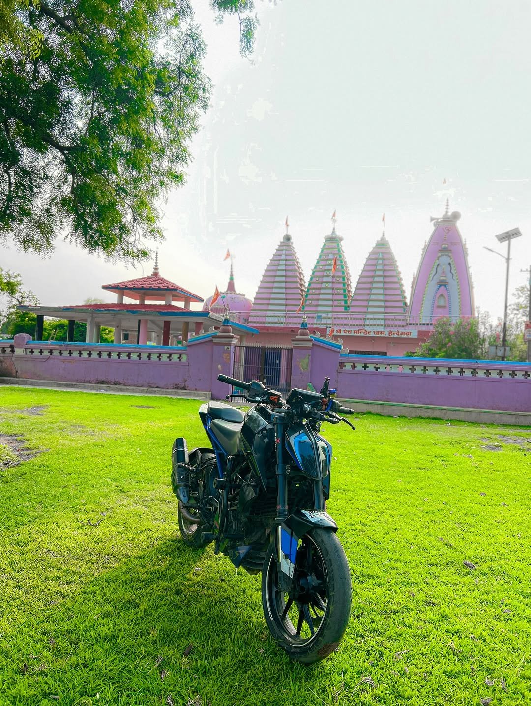 Photo by Vivek Kumar on June 10, 2025. May be an image of motorcycle, temple, outdoors and text.