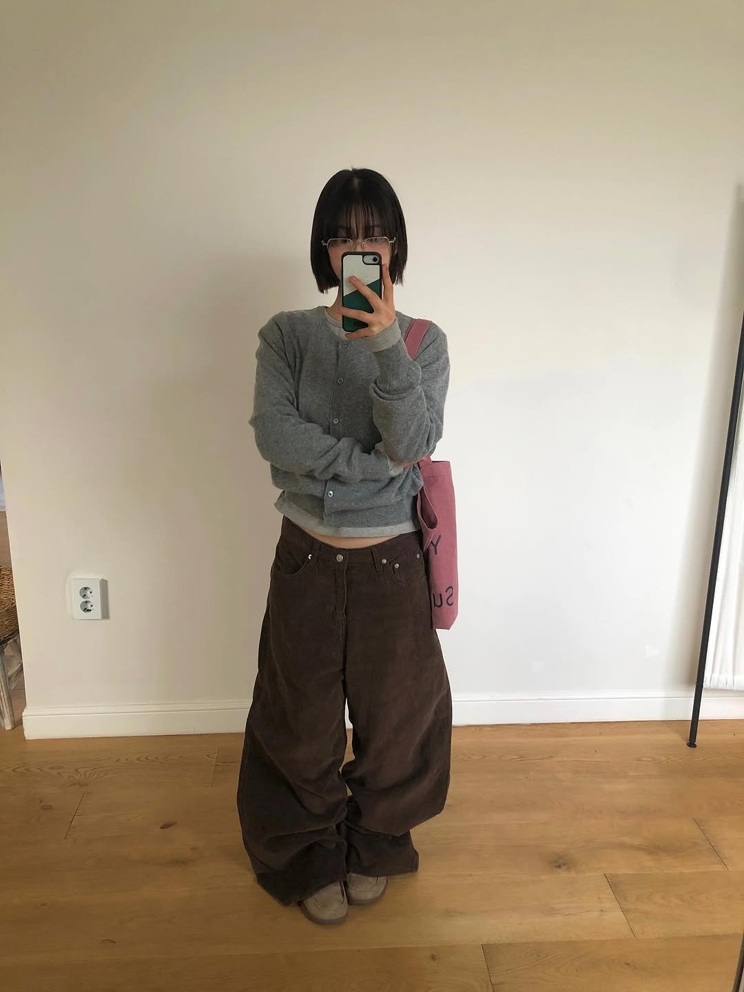 Photo by 진 / Jin on October 30, 2025. May be an image of standing, pants, turtleneck, sweatpants and text.