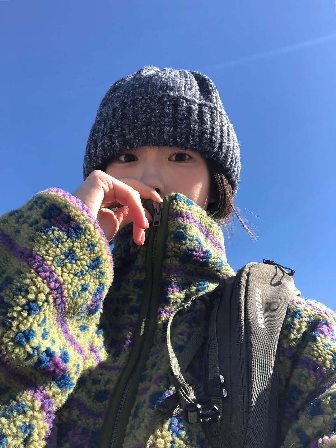 Photo by 진 / Jin on November 03, 2025. May be an image of duffle coat, goosedown coat, face mask, parka, flight jacket, turtleneck, snowsuit, ski slope and text.