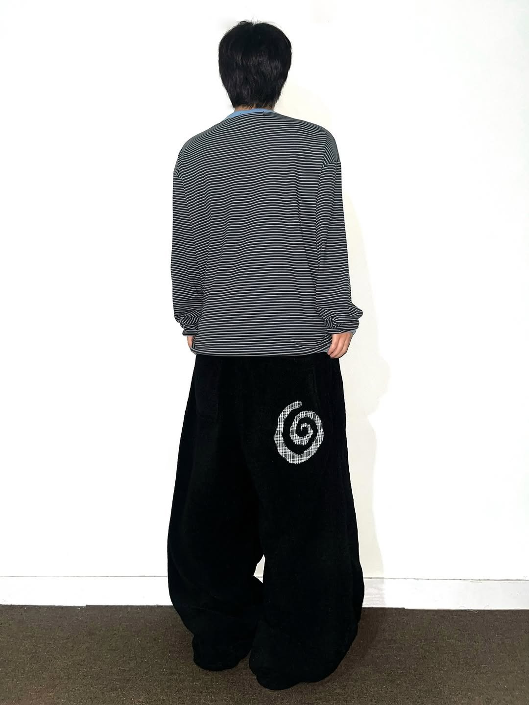 Photo shared by Chan / N’EST 네스트 on December 16, 2025 tagging @n_est.kr. May be an image of sportswear, sweatpants, stripes, sweatsuit and text.