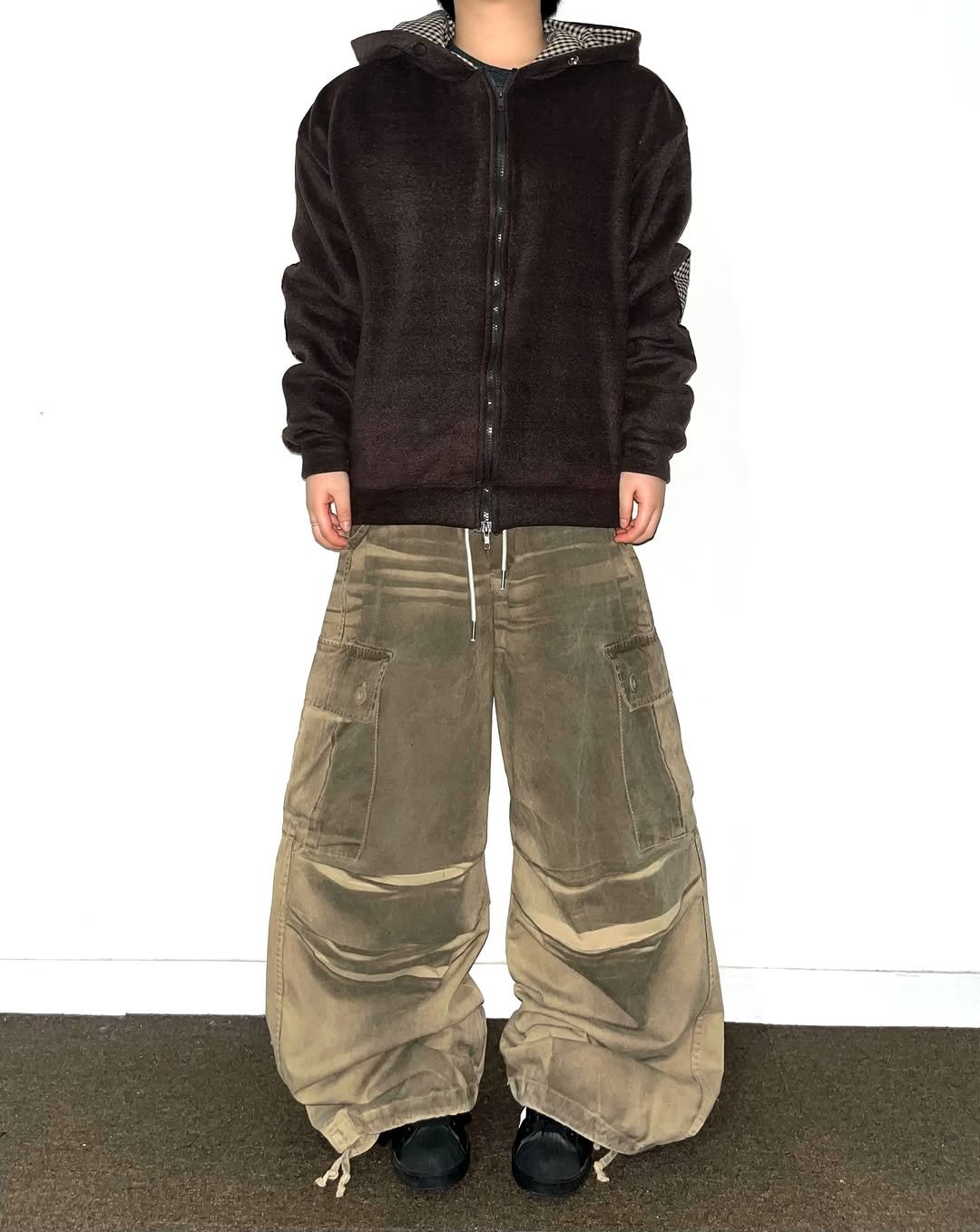 Photo shared by Chan / N’EST 네스트 on December 12, 2025 tagging @n_est.kr. May be an image of drawstring, parka, sweatpants and text.