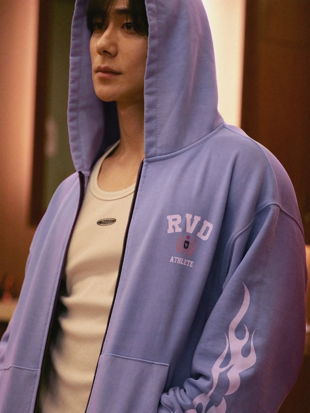 Photo shared by 박솔빈 on September 12, 2025 tagging @rvd_kr. May be an image of 1 person, bangs, makeup, sweatshirt, parka, top, bolo tie, sportswear and text that says 'RVD ATHLETE'.