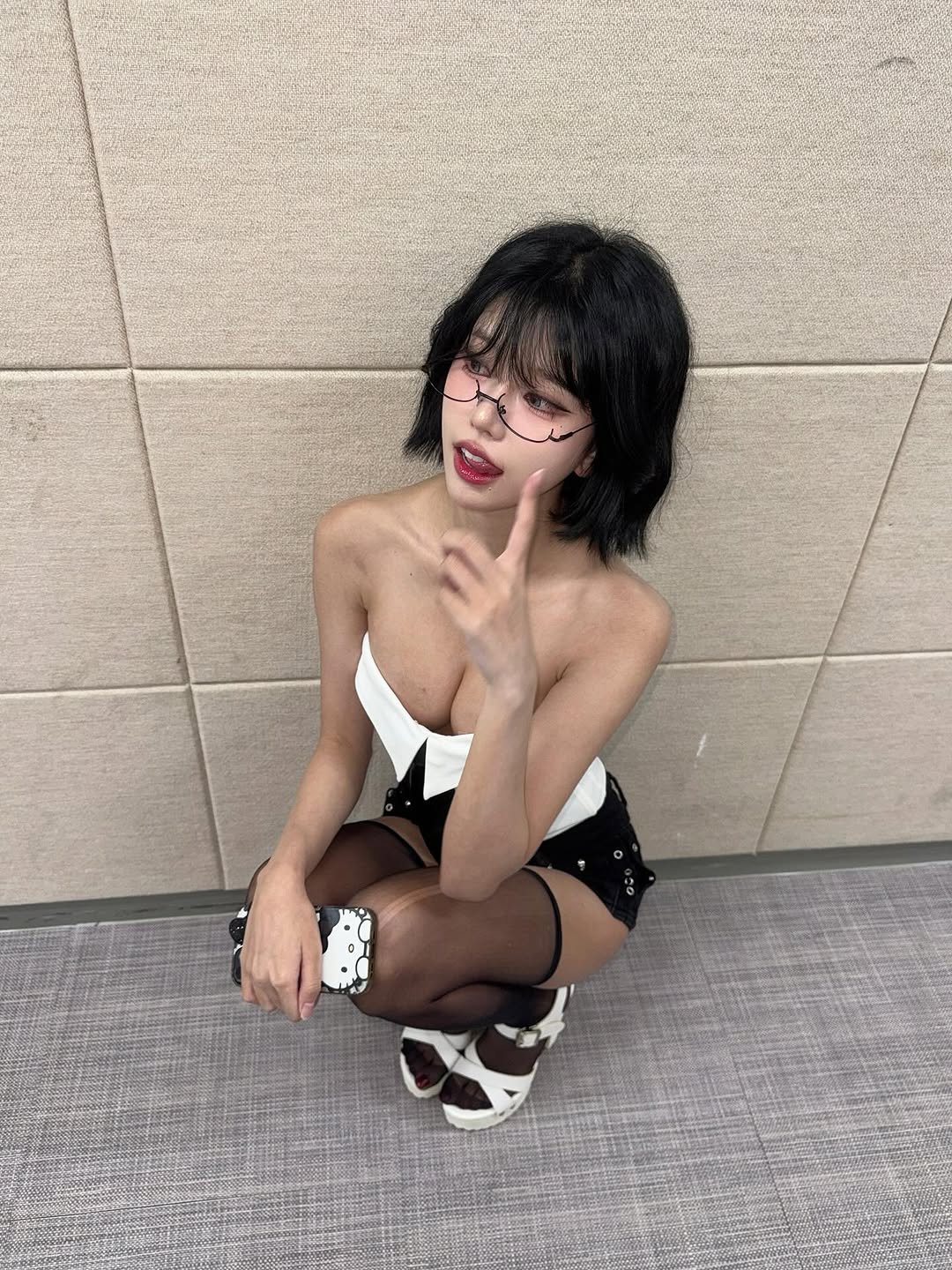 Photo by 최솜이 on September 22, 2025. May be an image of 1 person, makeup, costume, fishnet stockings, eye patch and text.