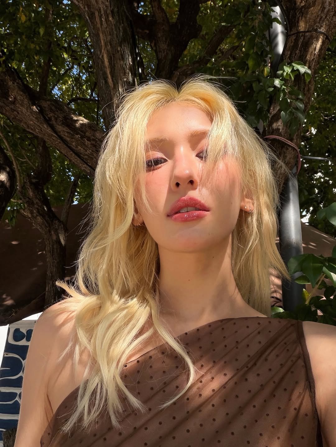 Photo by SOMI on December 09, 2025. May be an image of one or more people, blonde hair, makeup and text.