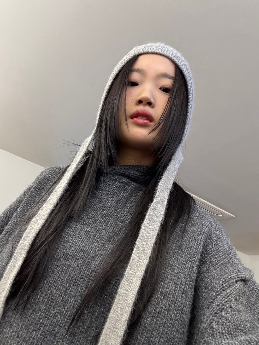 Photo shared by 아방 on December 11, 2025 tagging @lfm_official. May be a selfie of one or more people, braids, face mask, cloak, turtleneck, sweatshirt, parka, knit, sweater and text.