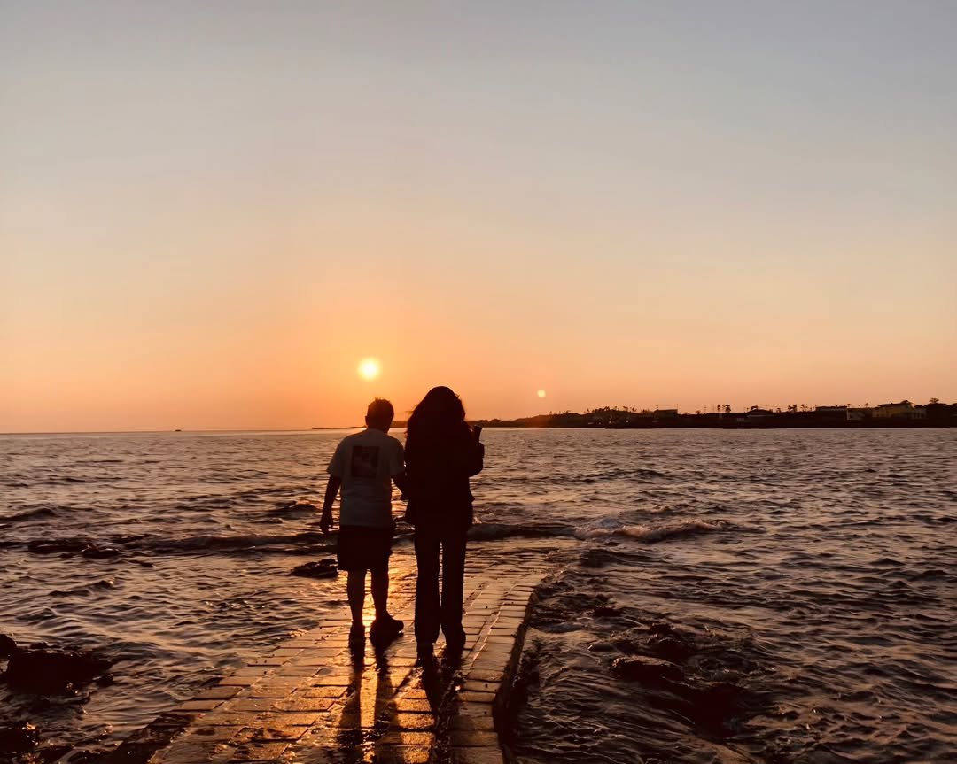 Photo by yoona on February 11, 2026. May be an image of one or more people, ocean, twilight, horizon and text.