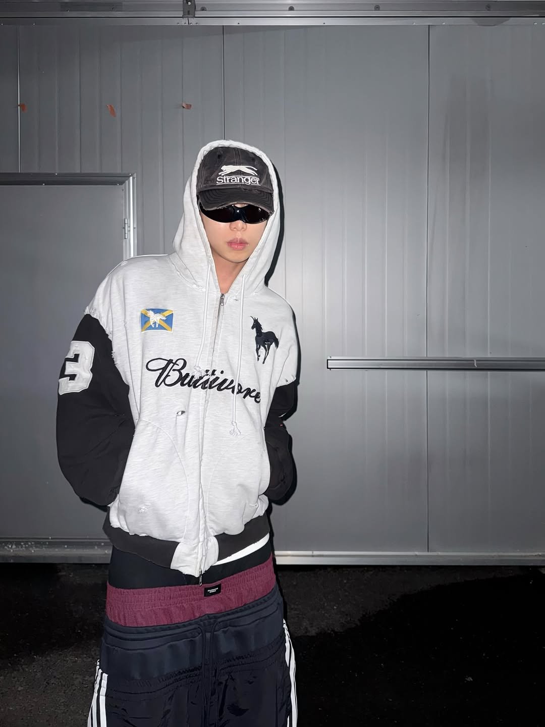 Photo shared by 소코년 sokonyun on October 08, 2025 tagging @protocol___index. May be an image of 1 person, hat, sweatpants, fleece, jacket, sweatshirt, parka, sweatsuit and text.