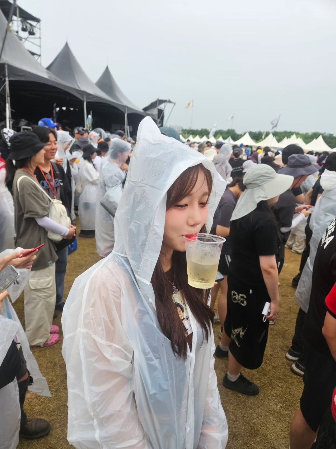 Photo by 수련 on August 04, 2025. May be an image of 6 people, umbrella, raincoat and text.