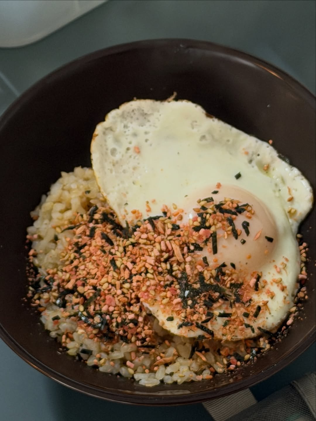 Photo by sookoh 수코 on March 17, 2026. May be an image of poached egg, fried rice, egg yolk, rice, seaweed and text.