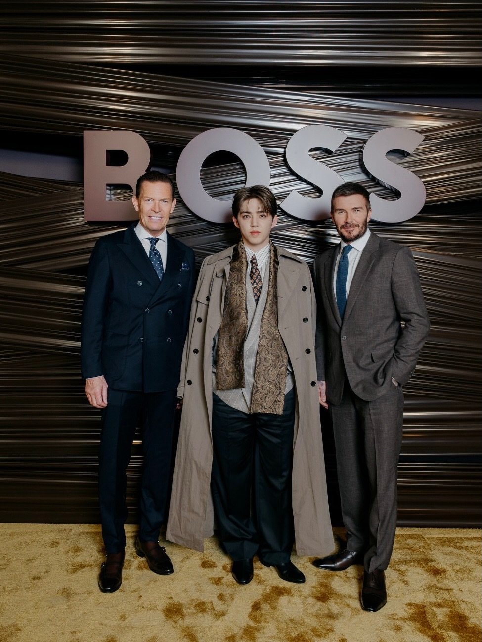 Photo shared by COUPS on February 26, 2026 tagging @davidbeckham, and @danielgrieder. May be an image of wrist watch, suit, magazine, dinner jacket, poster and text.