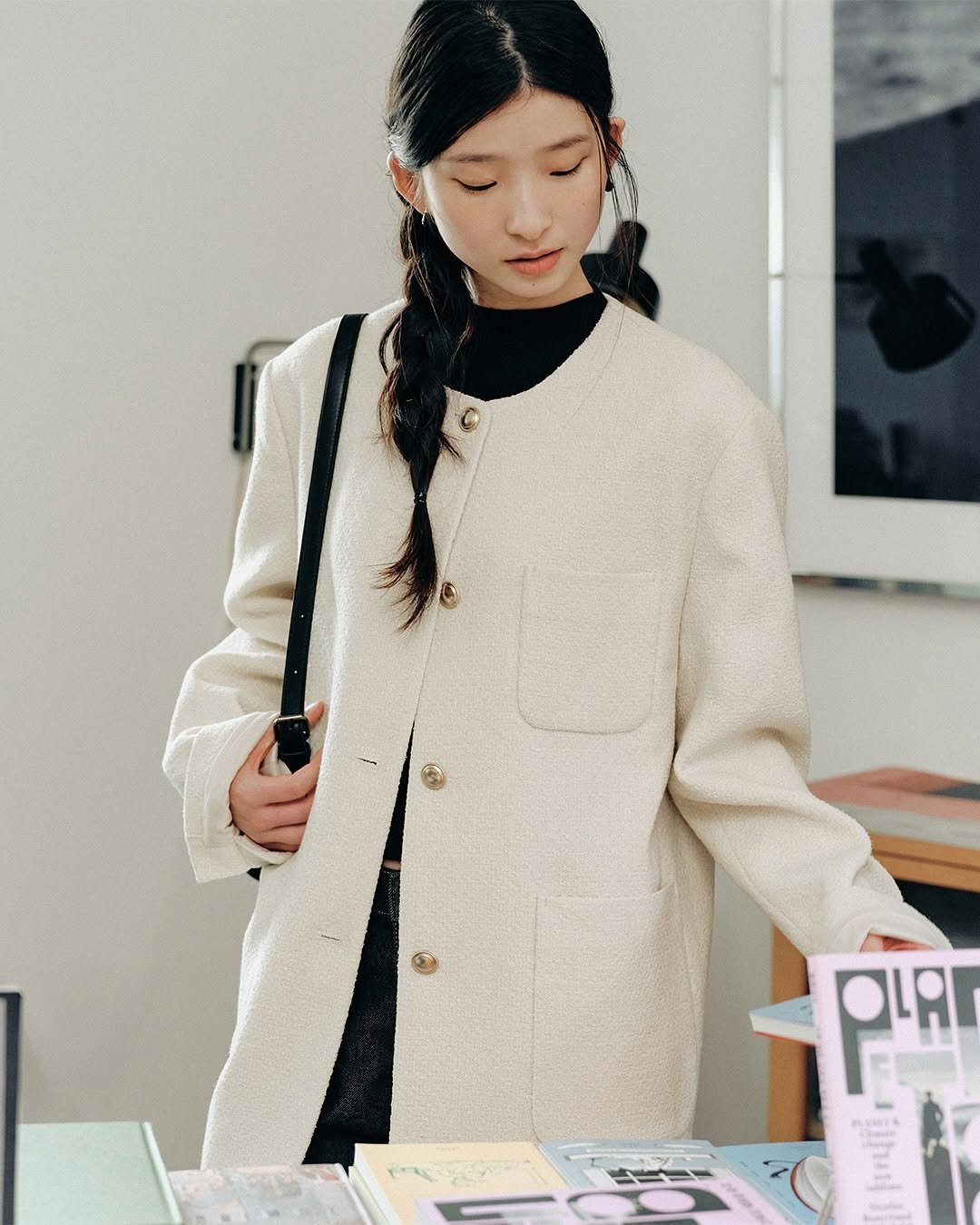 Photo by 스파오 on September 29, 2025. May be an image of one or more people, braids, duffle coat, overcoat, parka, turtleneck, dress and text.