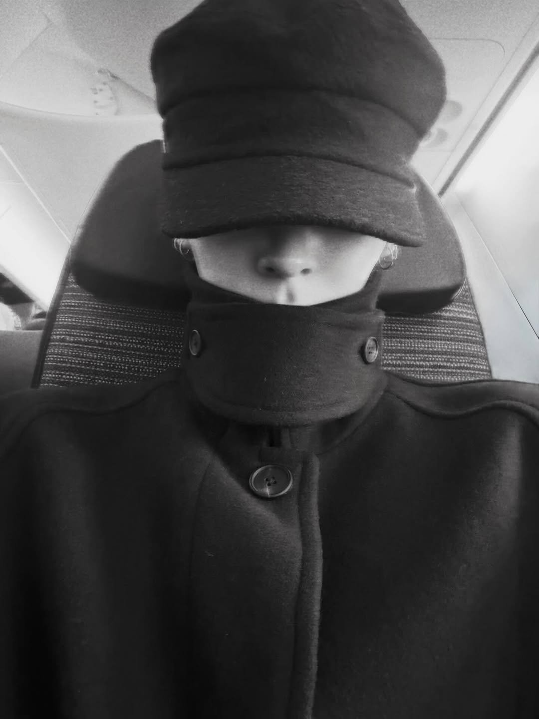 Photo by 세림 SERIM on December 01, 2025. May be a black-and-white image of overcoat, hat, duffle coat, face mask, parka and text.