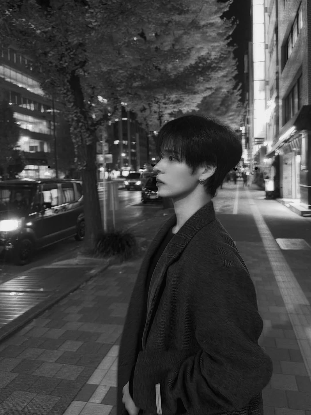 Photo by 세림 SERIM on November 20, 2025. May be a black-and-white image of one or more people, hair, duffle coat, overcoat, cigarette, street and text.