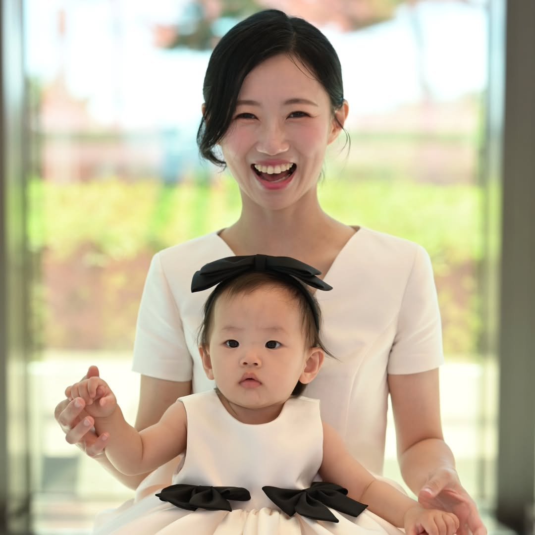 Photo shared by 슈쌤 on August 05, 2025 tagging @sshoosam. May be an image of 1 person, baby, bow, sundress and text.