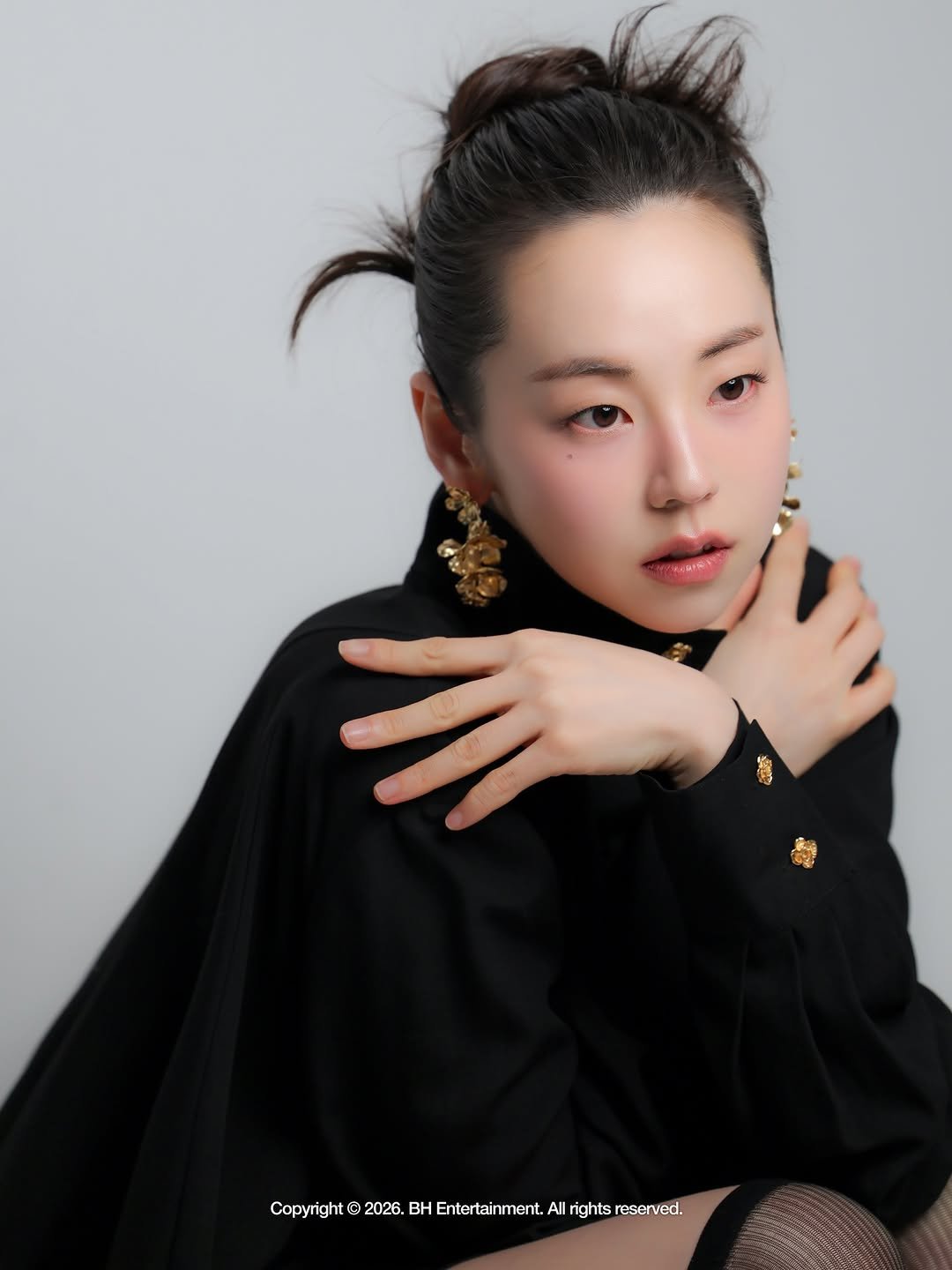 Photo shared by 안소희 on February 08, 2026 tagging @bhent_official. May be an image of one or more people, hair, makeup, turtleneck and text.