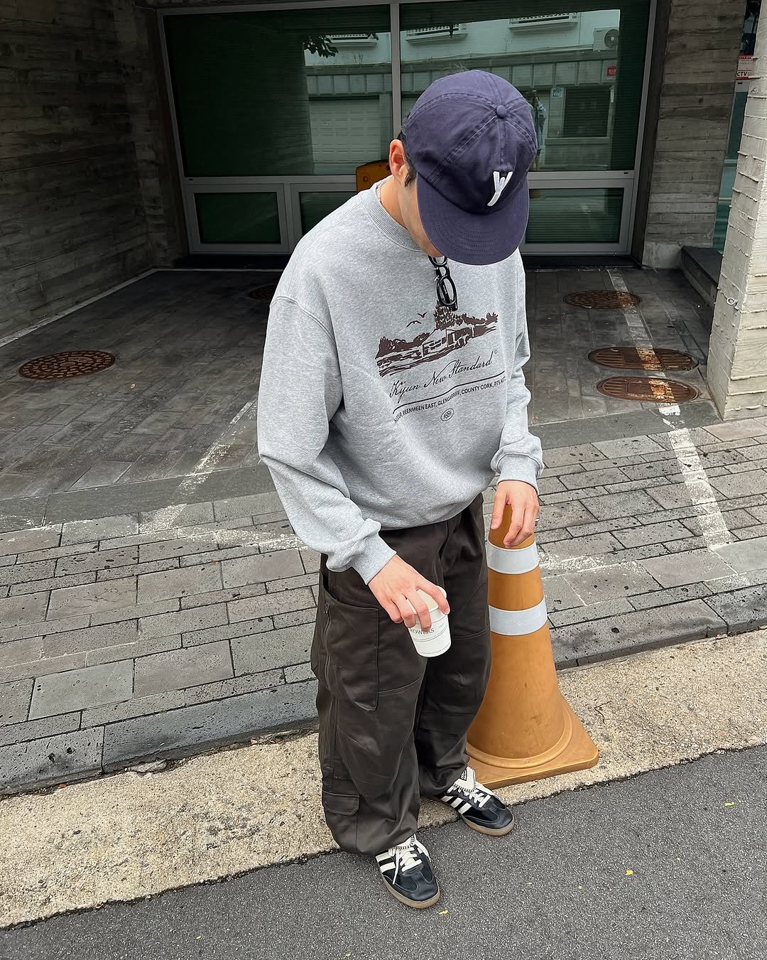 Photo by Euisun Sim 심의선 on September 12, 2025. May be an image of 1 person, skateboard, dustpan, bucket, sweatpants, sweatshirt, icecream cone, street, curb and text.