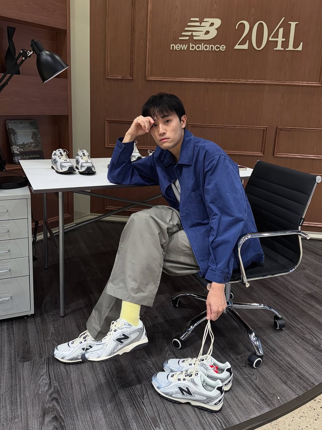 Photo shared by Euisun Sim 심의선 on September 18, 2025 tagging @newbalance. May be an image of 1 person, duffle coat, wingtip shoes, magazine, parka, toecap shoes, sneakers, sportswear and text.