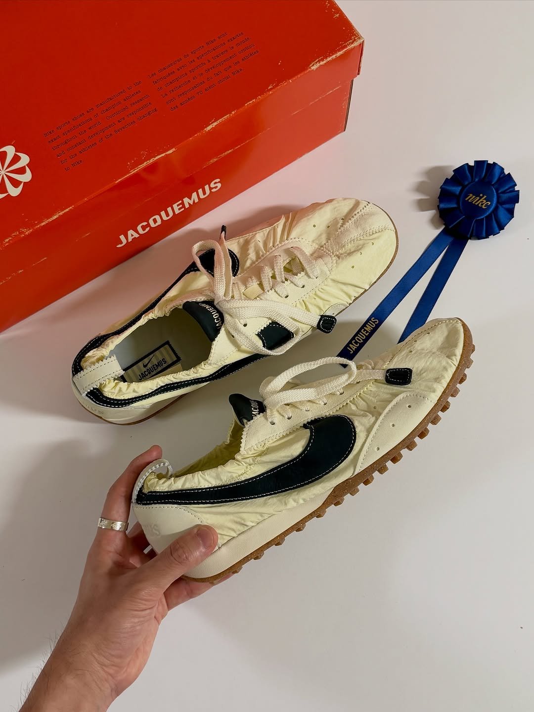 Photo shared by Euisun Sim 심의선 on October 18, 2025 tagging @nike, and @jacquemus. May be an image of sneakers and text.