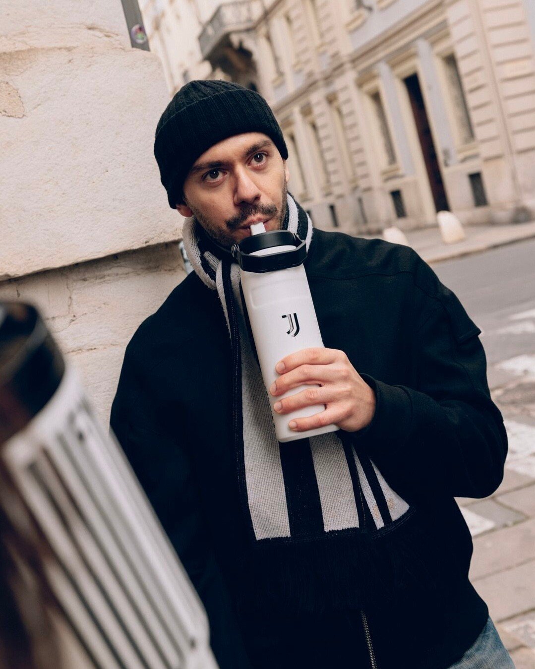 Photo by Stanley Indonesia on April 02, 2026. May be an image of one or more people, beard, coffee cup, water bottle, cigarette, outerwear, flask, cup, cornflower, street and text.