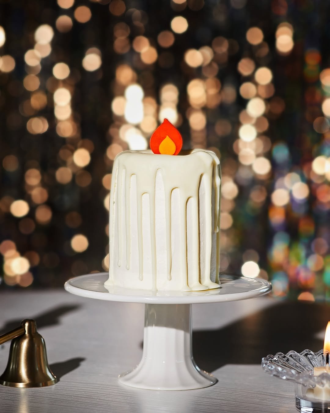 Photo by 스타벅스 코리아 on October 29, 2025. May be an image of wedding cake, candle holder, sparkler, candle and text.