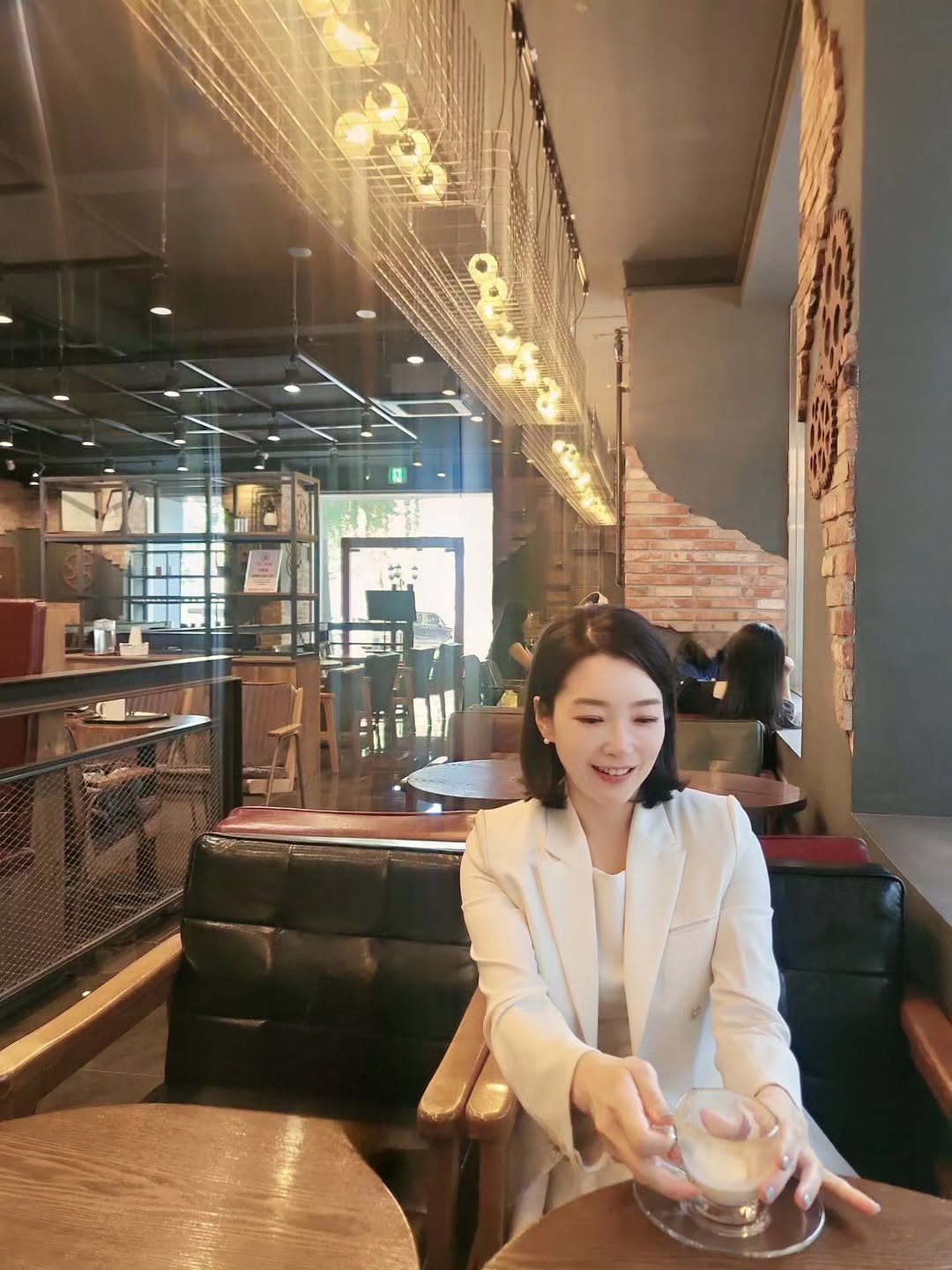 Photo by 염지혜 on September 12, 2025. May be an image of 1 person, drink, blazer and text.