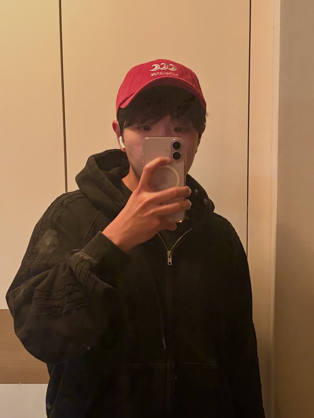 Photo shared by Stoney Choi on April 21, 2026 tagging @wethecultureseoul. May be a selfie of phone, hat, duffle coat, sweatshirt, parka, mirror, jacket and text.