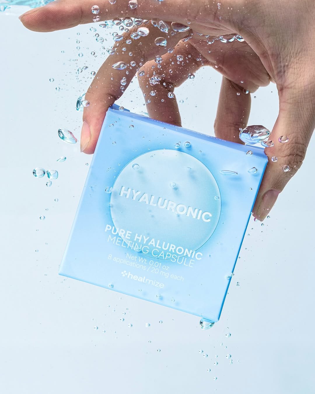 Photo by 스튜디오 쿠드 - 룩북촬영 | 영상촬영 | 제품촬영 on July 11, 2025. May be an image of 1 person, makeup, bar soap, hand cream, water filter, cosmetics and text that says 'モンキン មា HYALURONIC HYALURONIC RONIC PURE MELTING HYALURONIC Wt. ns/ 0.01 8 applications applications/20mgeach Net CAPSULE OZ *healmize mg each /20m'.