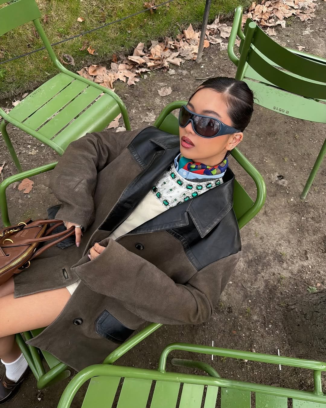 Photo shared by steph hui on March 11, 2026 tagging @miumiu. May be an image of overcoat, eyewear, turtleneck, jacket and text.