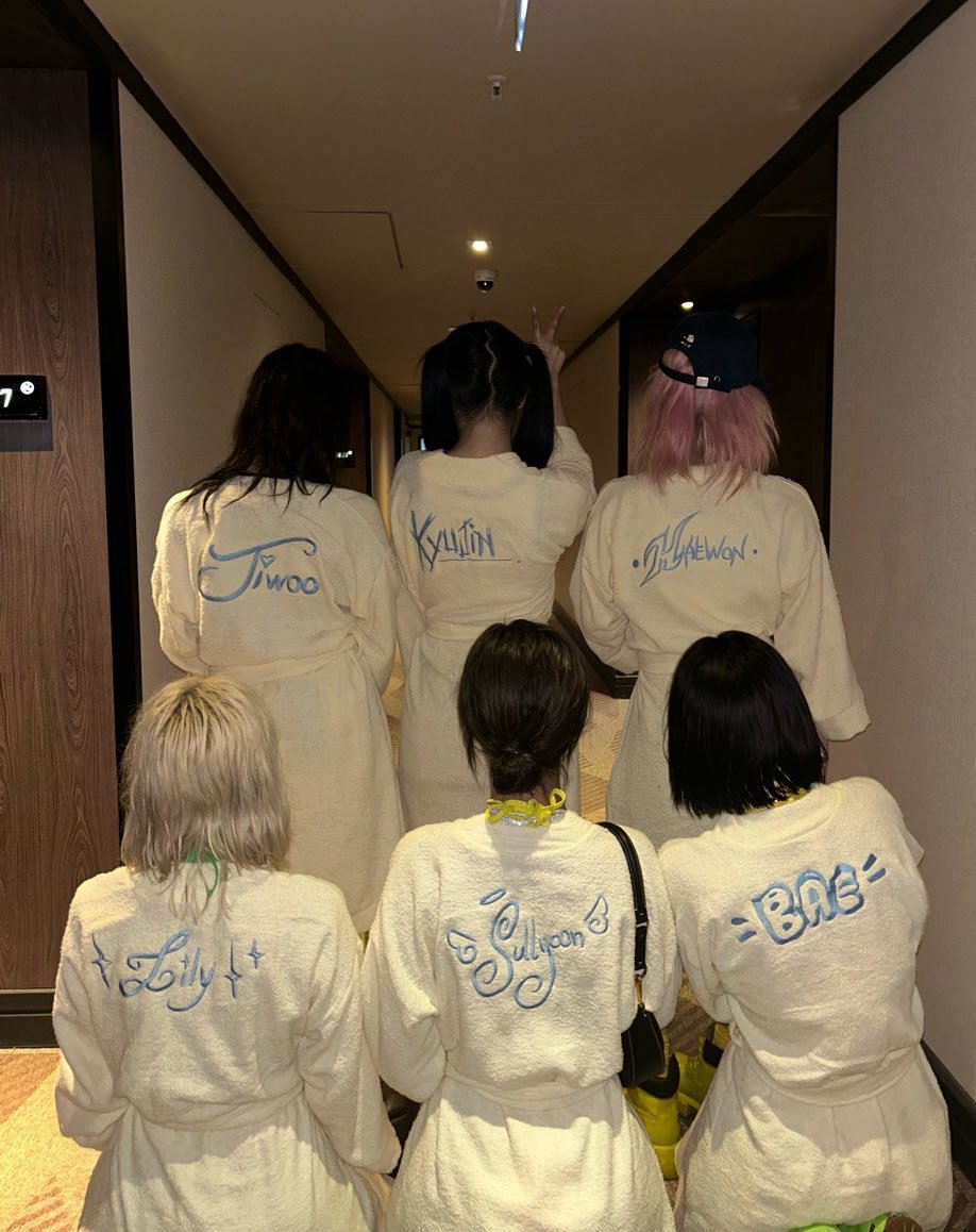 Photo shared by NMIXX 엔믹스 SULLYOON 설윤 on February 18, 2026 tagging @nmixx__ohhaewon, @nmixx_kyujin, @jiwoo_nmixx, @sullyoon_nmixx, @bae__nmixx, and @lily_nmixx. May be an image of robe, bath robe and text.