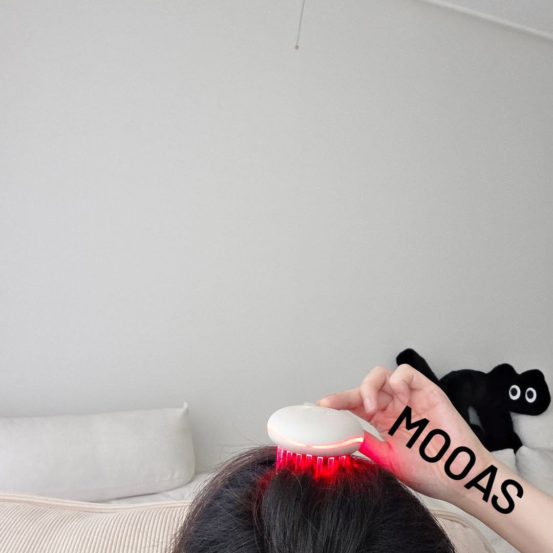 Photo shared by 방말금 on September 25, 2025 tagging @mooas_official. May be an image of 1 person, makeup, hair brush, hair dryer, comb, brush and text.