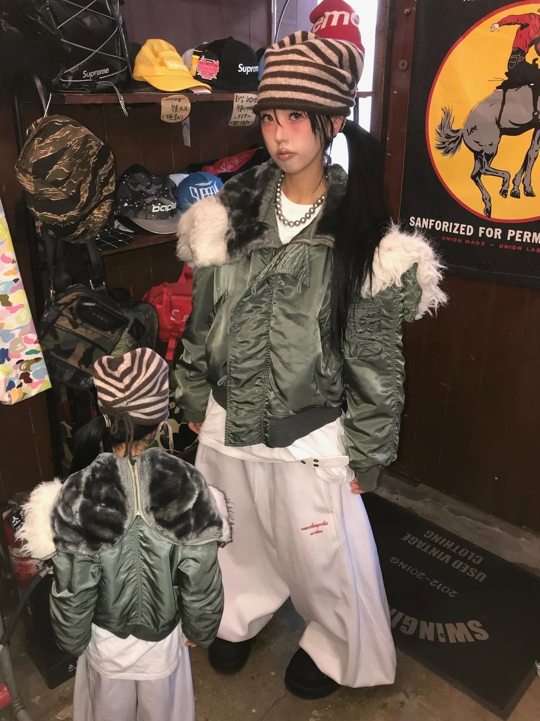 Photo by 스윙잉서울 대구 on December 04, 2025. May be an image of duffle coat, hat, goosedown coat, military uniform, mannequin, parka, snowsuit and text.