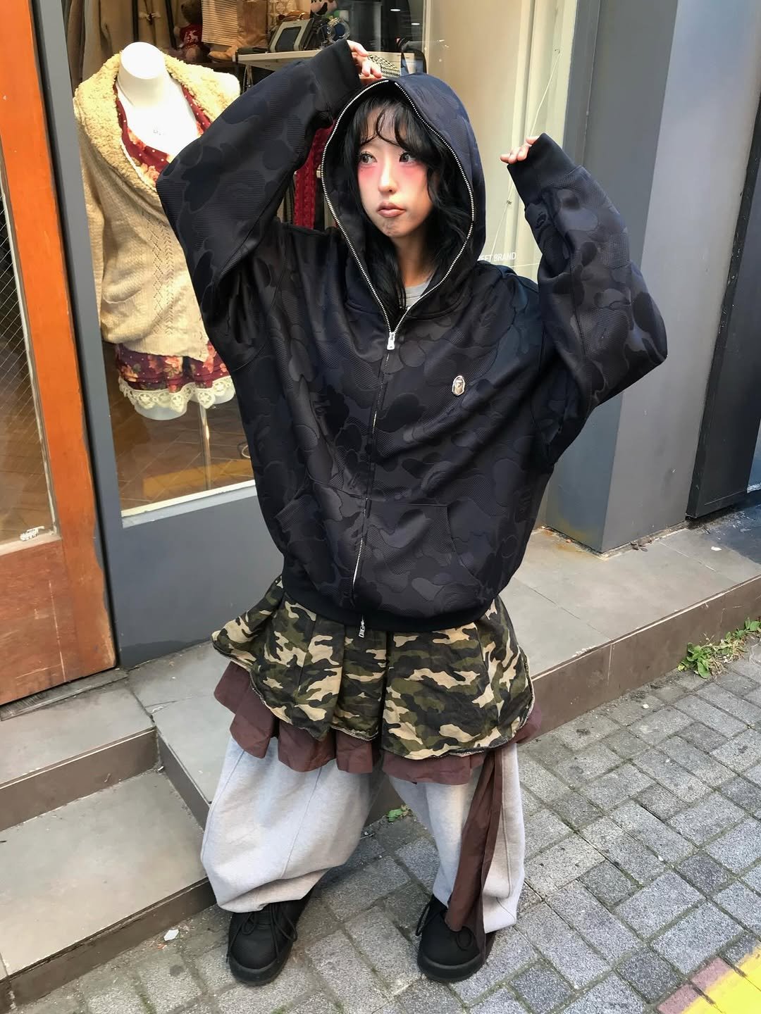 Photo shared by 스윙잉서울 대구 on December 03, 2025 tagging @bape_japan. May be an image of duffle coat, cloak, kilt, raincoat, parka, military uniform and text.