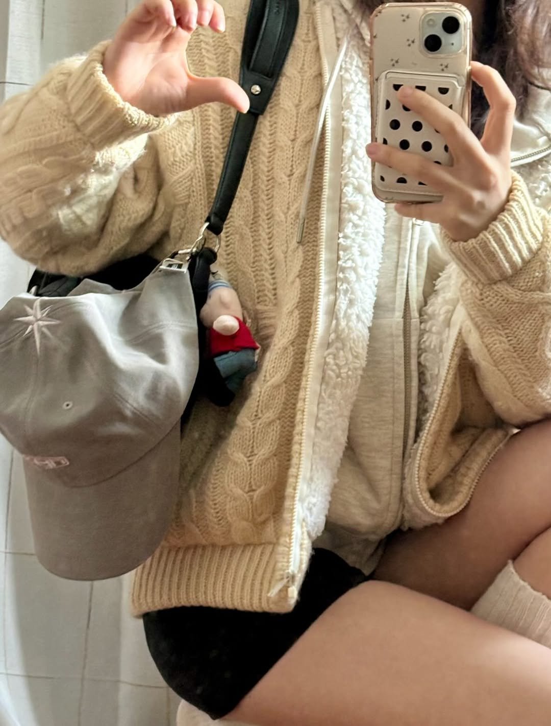 Photo shared by 세영 on December 29, 2025 tagging @noeyedeer_hq, and @marieclaire.korea. May be a selfie of duffle coat, hat, phone, sweatshirt, shorts, sweater, miniskirt and text.