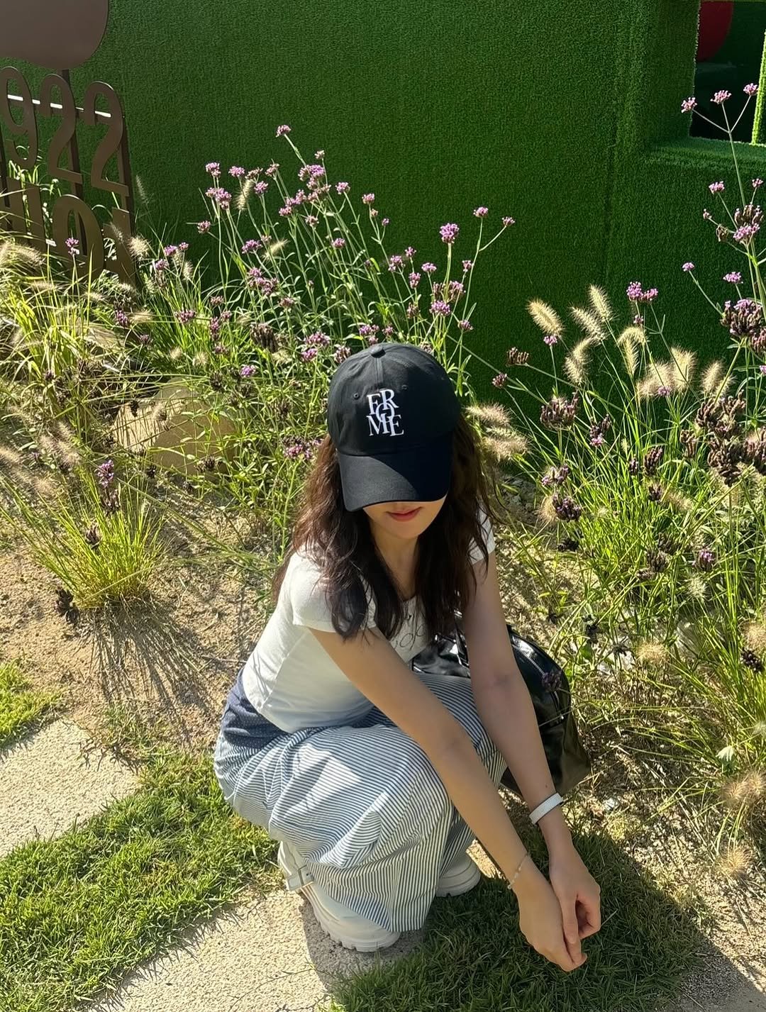 Photo shared by 세영 on September 10, 2025 tagging @onaemn_. May be an image of 1 person, hat, grass and text.