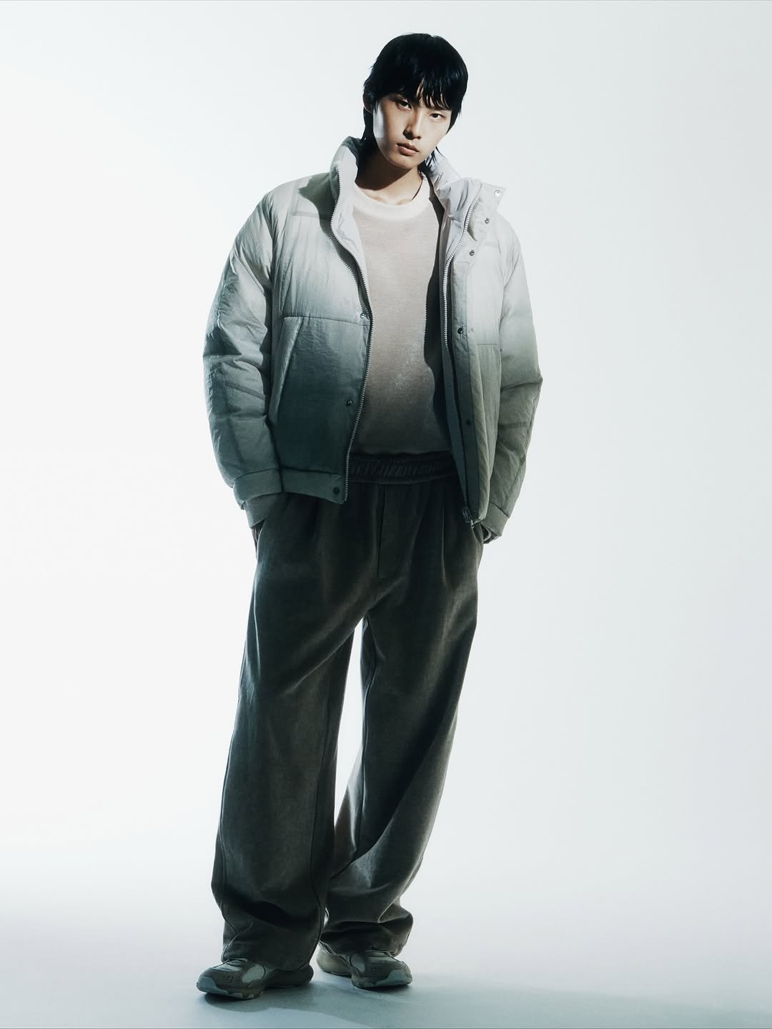 Photo by SYSTEM, SYSTEM HOMME on October 24, 2025. May be an image of one or more people, bangs, goosedown coat, overcoat, duffle coat, jacket, sweatpants, parka and text.