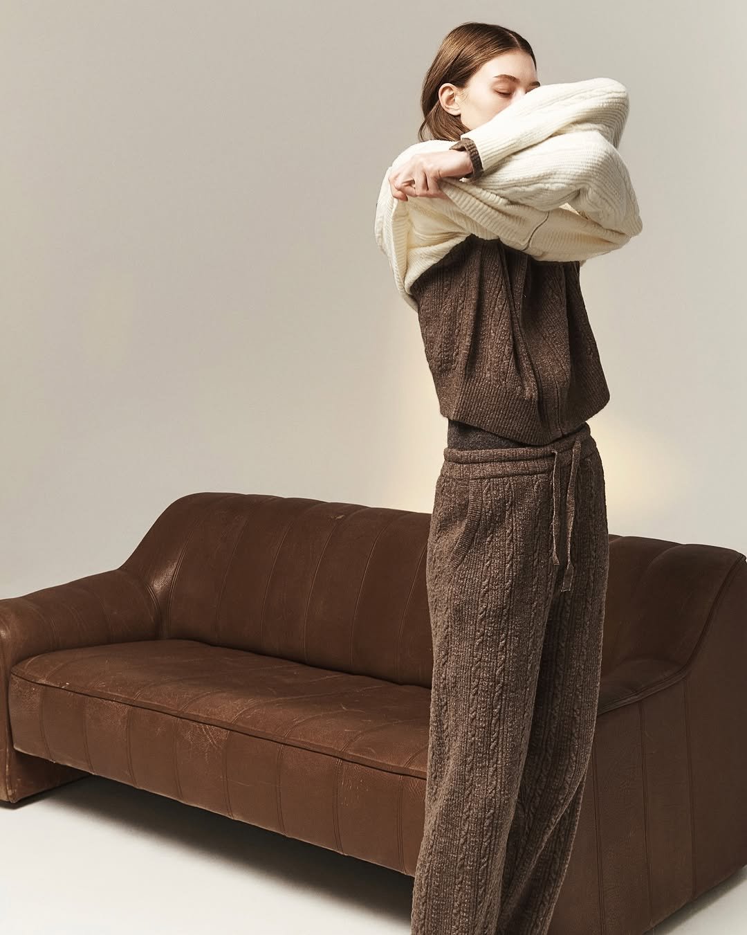 Photo by SYSTEM, SYSTEM HOMME on November 24, 2025. May be an image of sweatpants, turtleneck and text.