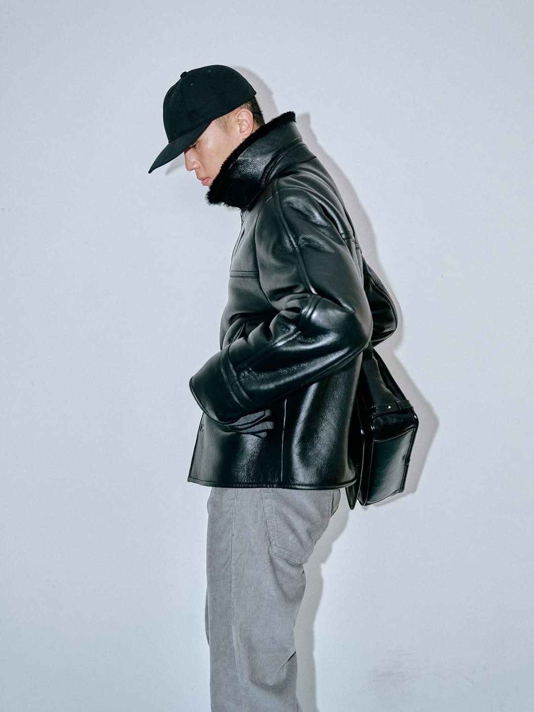 Photo by SYSTEM, SYSTEM HOMME on December 03, 2025. May be an image of leather, duffle coat, overcoat, jacket and text.