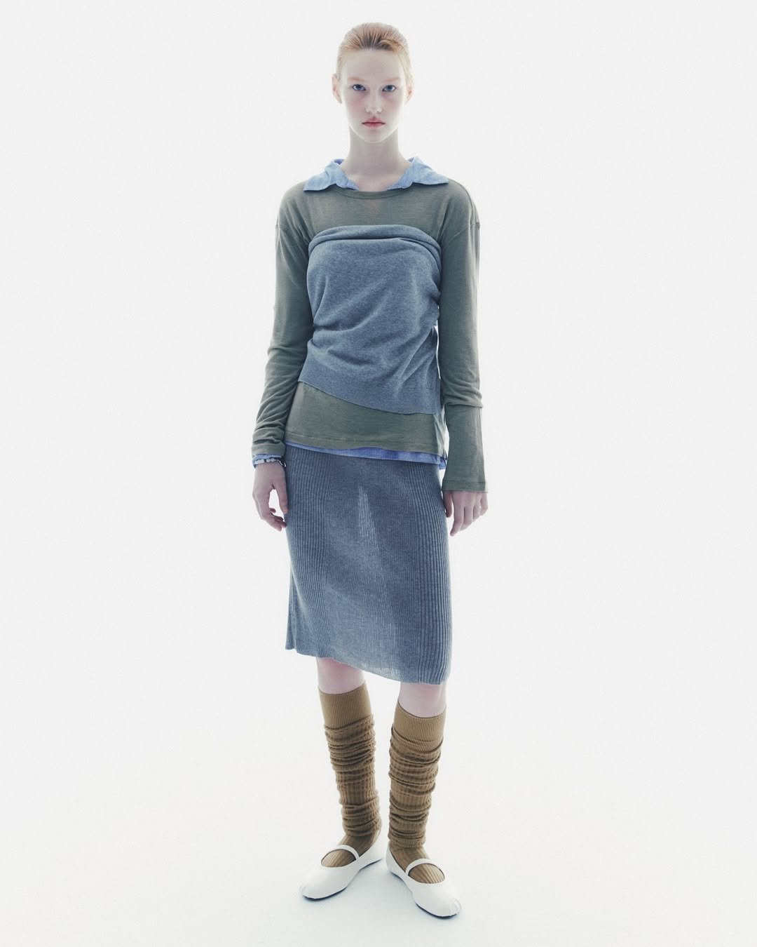 Photo by SYSTEM, SYSTEM HOMME on September 04, 2025. May be an image of 1 person, miniskirt, turtleneck, wool and text.