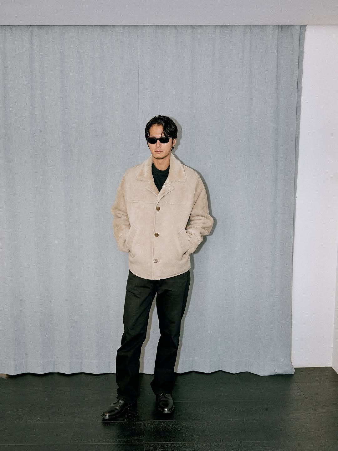 Photo by SYSTEM, SYSTEM HOMME on December 05, 2025. May be an image of duffle coat, overcoat, eyewear, turtleneck and text.