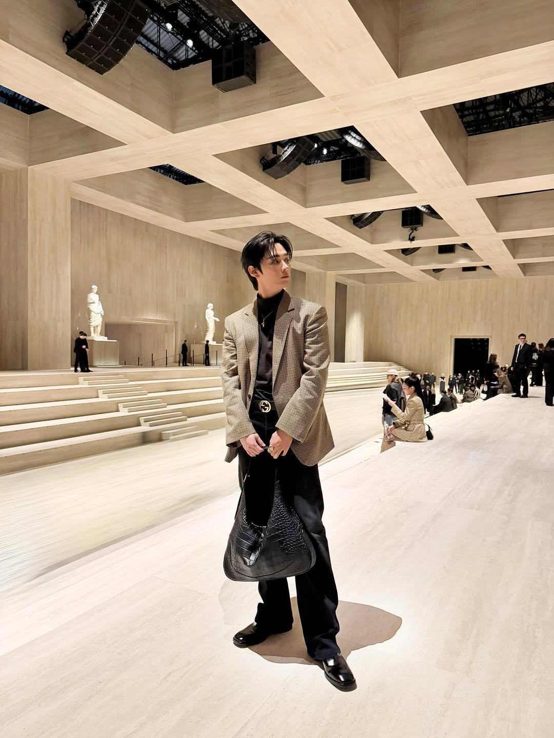 Photo shared by GUCCI on March 01, 2026 tagging @t.leeknowsaurus. May be an image of overcoat and text.